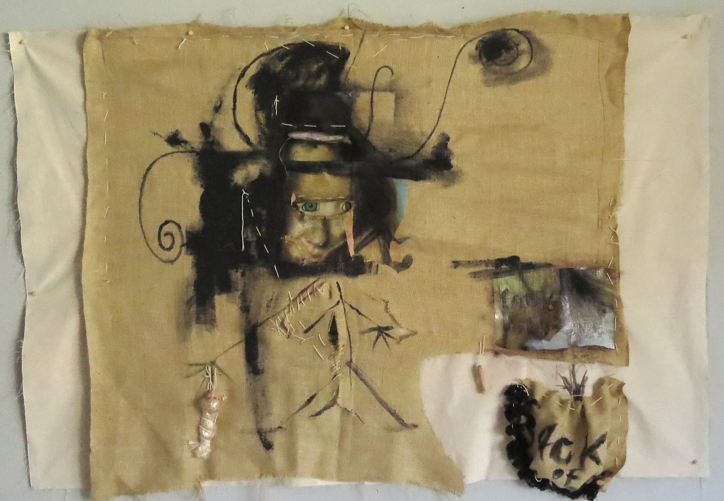 Sack of Sorrows, Mixed media on fabric: acrylic, charcoal, photographic transfers, hand stitching, and textile collage, 2026