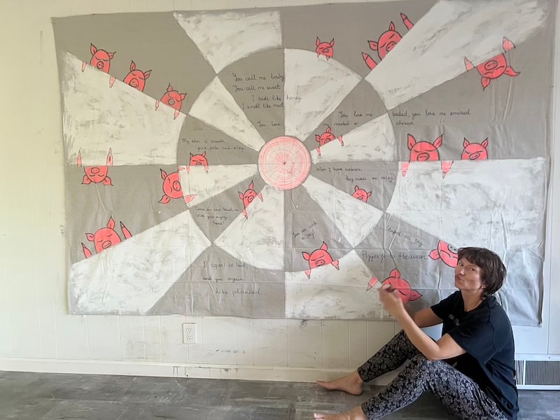 Marina Orlova creating large mandala wall mural in studio