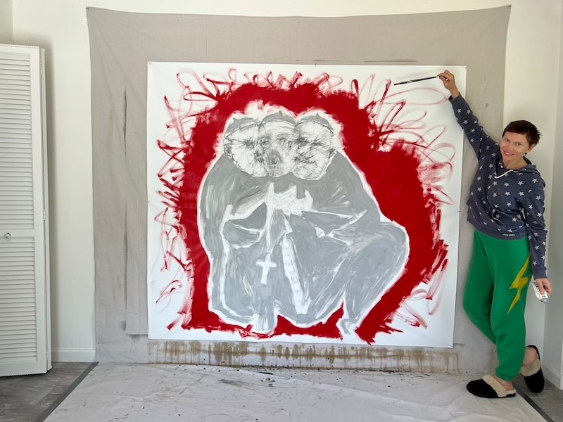 Marina Orlova painting large red abstract portrait in studio